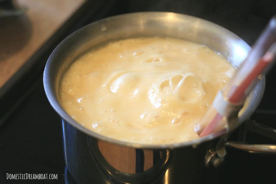 A saucepan containing boiling sugar mixture.