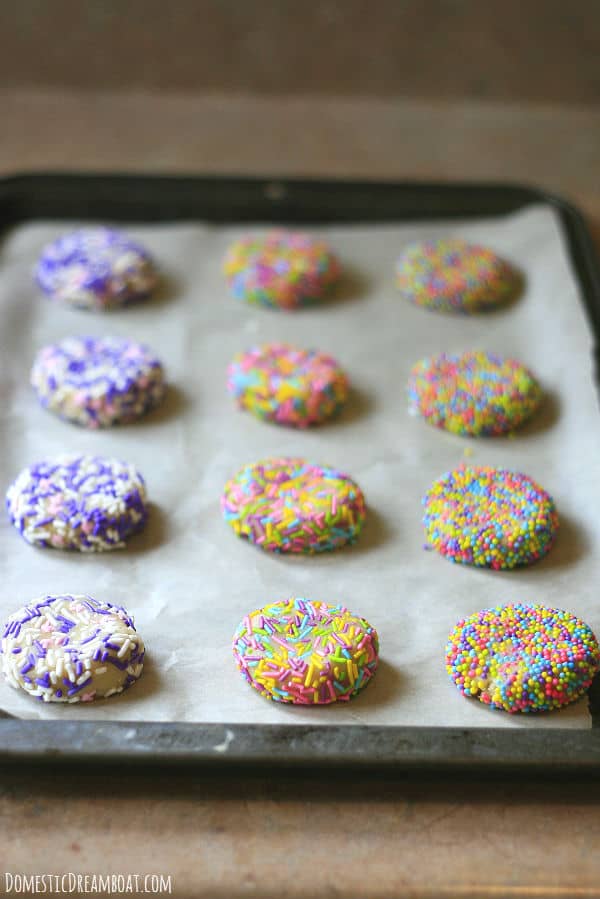 Discs of sugar cookie dough covered in sprinkles.