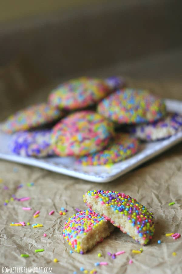 A plate of sprinkle covered sugar cookies.
