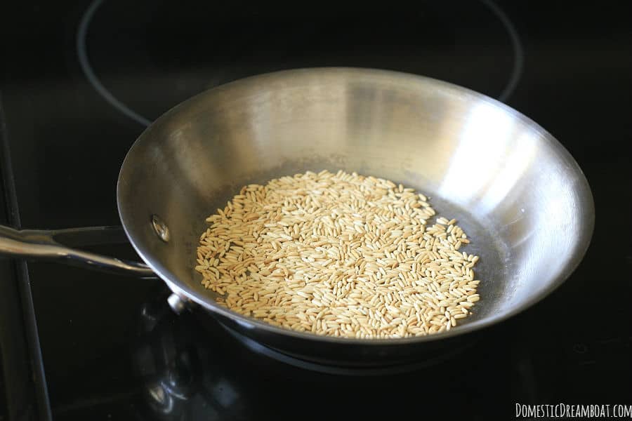 Roasted rice in a stainless steel skillet.