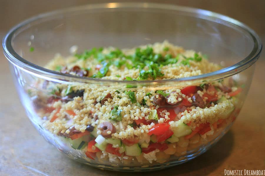 Chickpea and quinoa salad in a glass bowl before mixing
