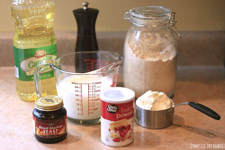 The ingredients to make Homemade Whole Wheat Crumpets: canola oil, milk, water, all-purpose flour, whole wheat flour, salt, baking powder, and yeast.