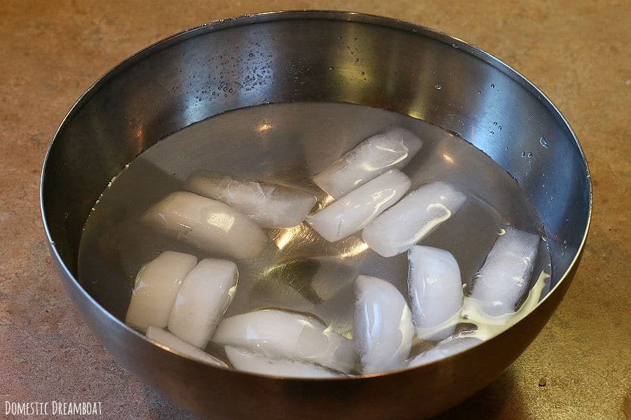 Ice water in a stainless steel bowl.