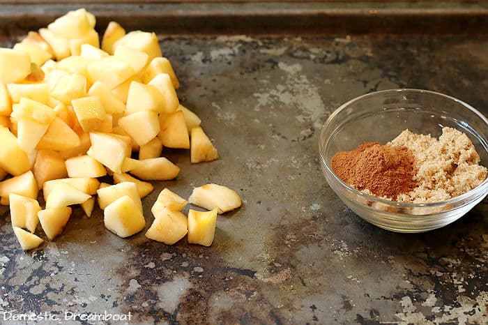 Ingredients to make homemade apple pie filling - chopped apples, brown sugar, and cinnamon.