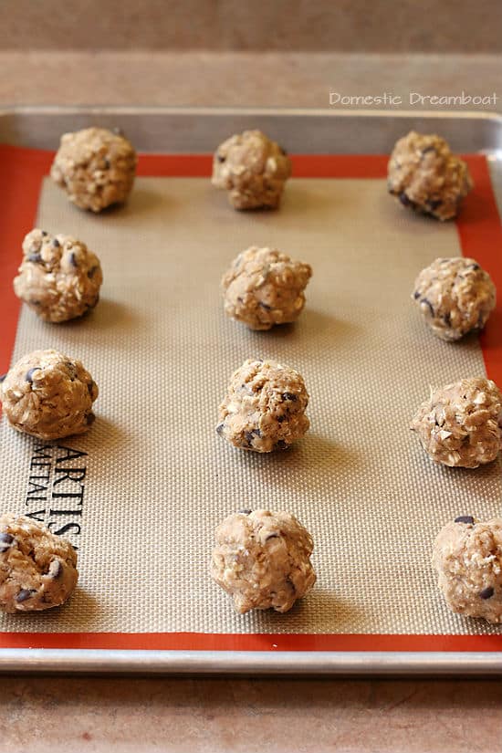 Unbaked Oatmeal Chocolate Chip Lactation Cookies on a baking sheet.