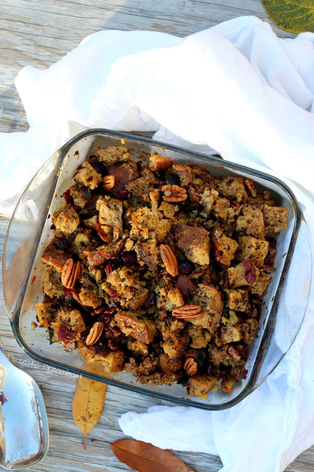 Overhead photo of bread Stuffing with Dried Cranberries and Pecans in a glass baking dish.