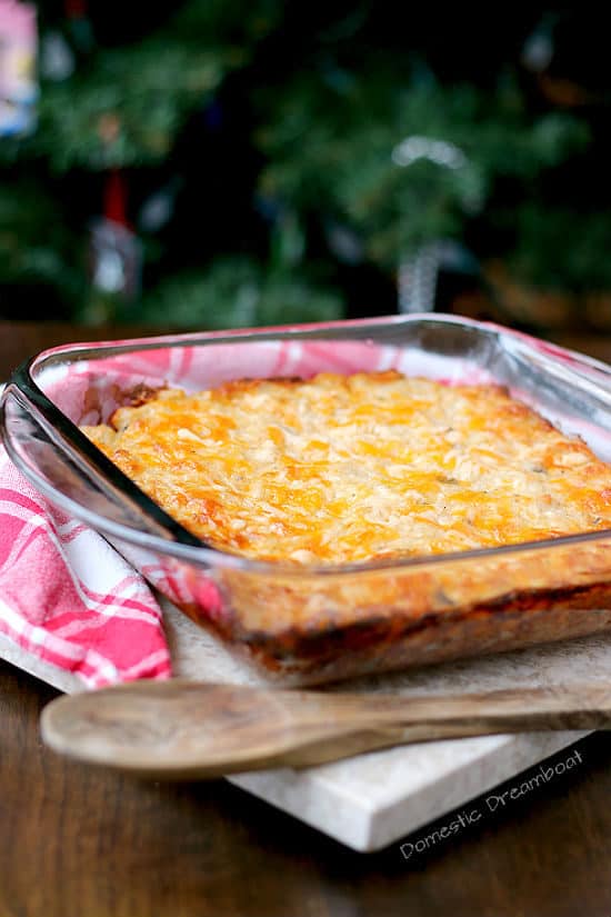 Cheesy hashbrown casserole in a glass baking dish.