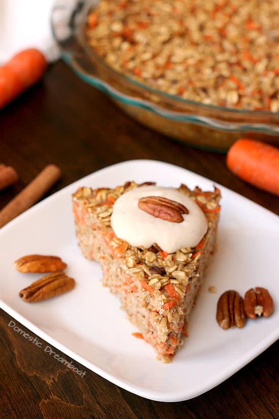 Carrot Cake Baked Oatmeal with Cream Cheese Topping on a white plate.