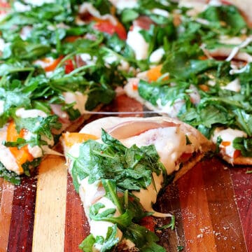 Slice of prosciutto arugula pizza