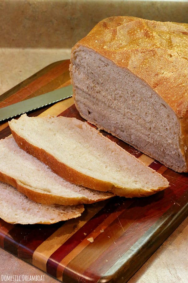 Sliced sourdough bread on a wood cutting board