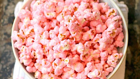 Overhead photo of pink popcorn in a bowl.