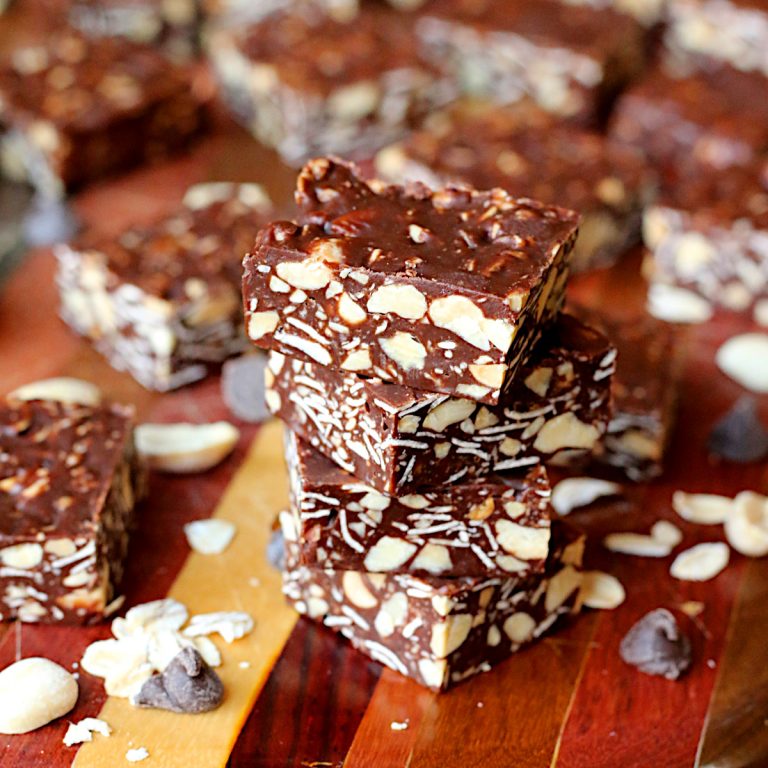 A stack of homemade Eatmore squares on a wood cutting board.