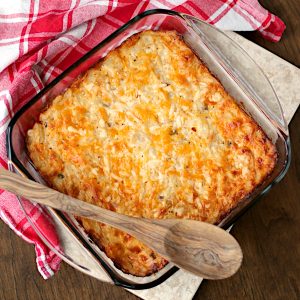 Overhead photo of cheesy hashbrown casserole in a glass baking dish.
