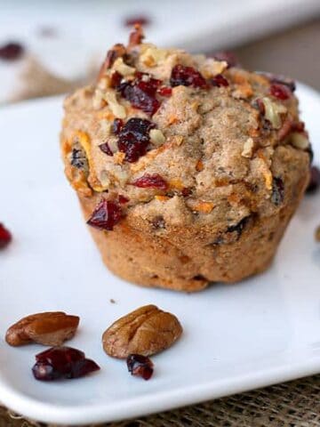 Whole cranberry muffin on a plate