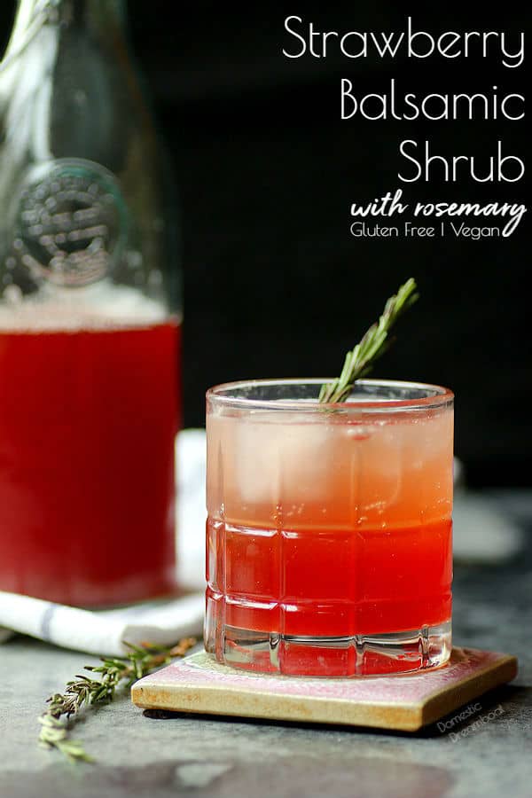 Glass of strawberry shrub with rosemary garnish