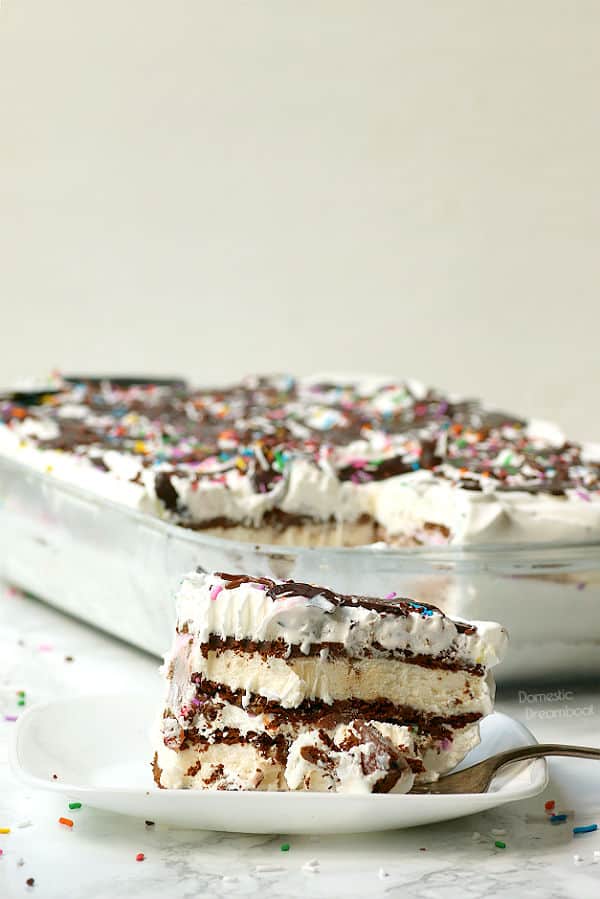 Slice of ice cream sandwich cake with sprinkles and chocolate