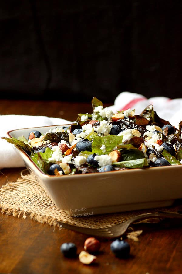 Closeup photo of salad with blueberries, feta cheese, and hazelnuts in a bowl