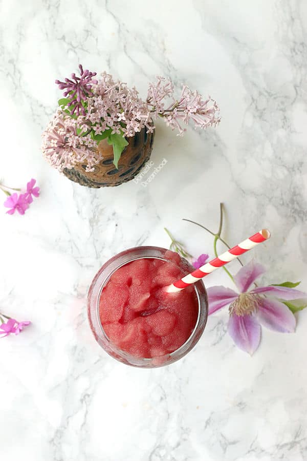 Overhead photo of frozen rosé slushie surrounded by flowers