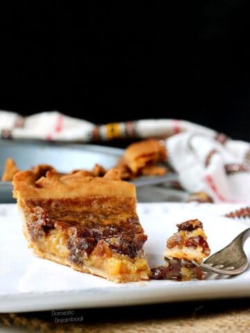 Slice of butter tart pie and a fork on a plate