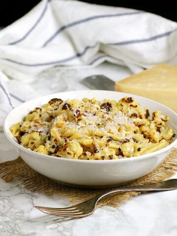Pasta with roasted cauliflower in a white bowl
