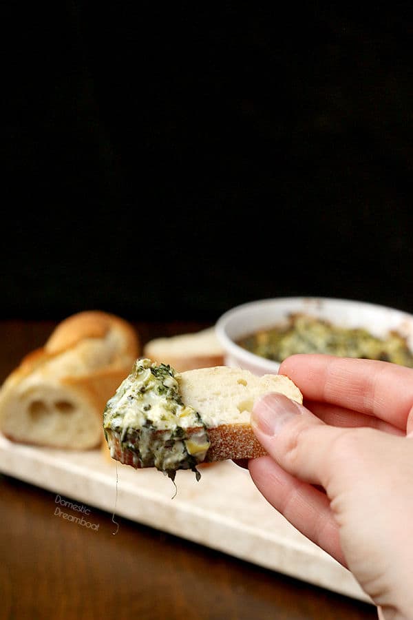 spinach artichoke dip on a slice of baguette