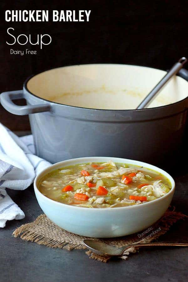 Chicken barley soup in a light blue bowl