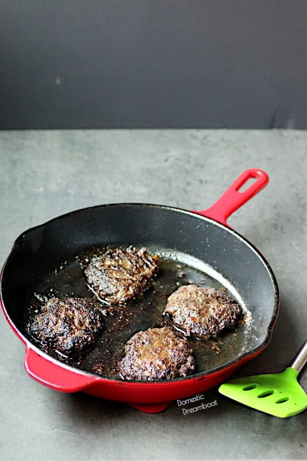 Cooked hamburger patties in a skillet