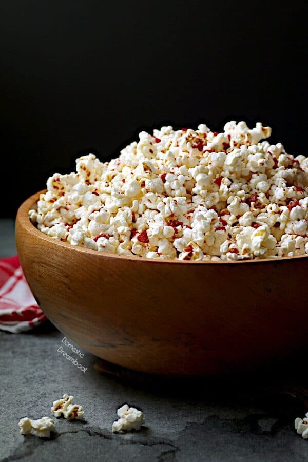 A large wooden bowl of popcorn.