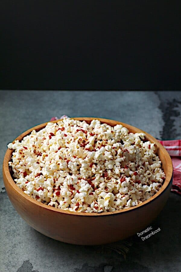 Large wooden bowl filled with popcorn