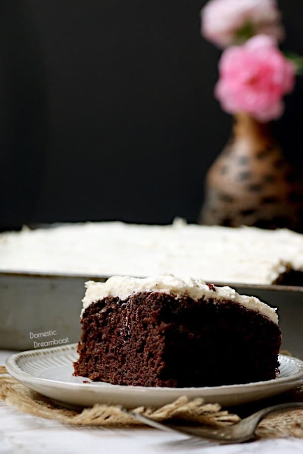 Easy Copycat Deep 'n Delicious Cake Frosting A slice of chocolate zucchini cake on a white plate