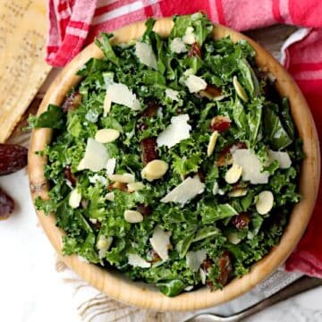 Overhead photo of kale and date salad in a wood bowl.