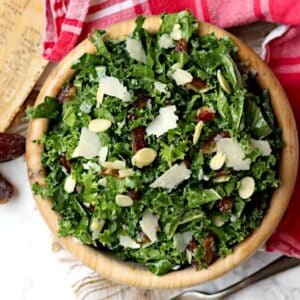 Overhead photo of kale and date salad in a wood bowl.