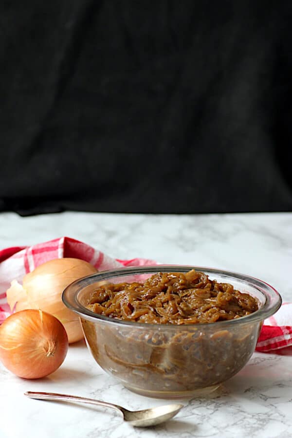 Caramelized onions in a clear glass bowl.