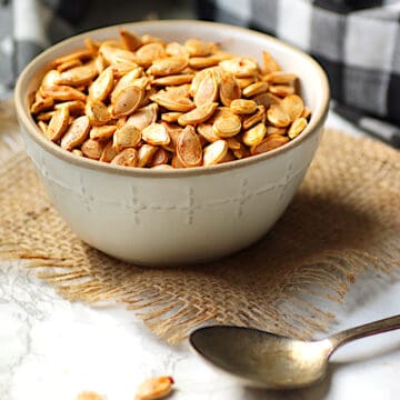 Homemade roasted pumpkin seeds in a bowl.