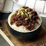 Korean beef and mushrooms over rice in a black bowl.