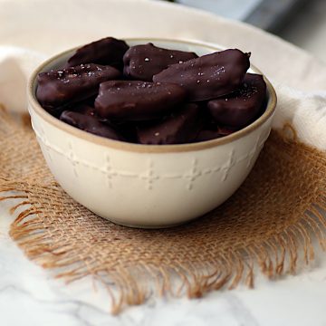 Chocolate Covered Dates in a white bowl.