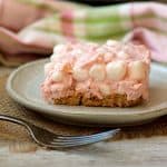A tropical cherry ambrosia square on a white plate.
