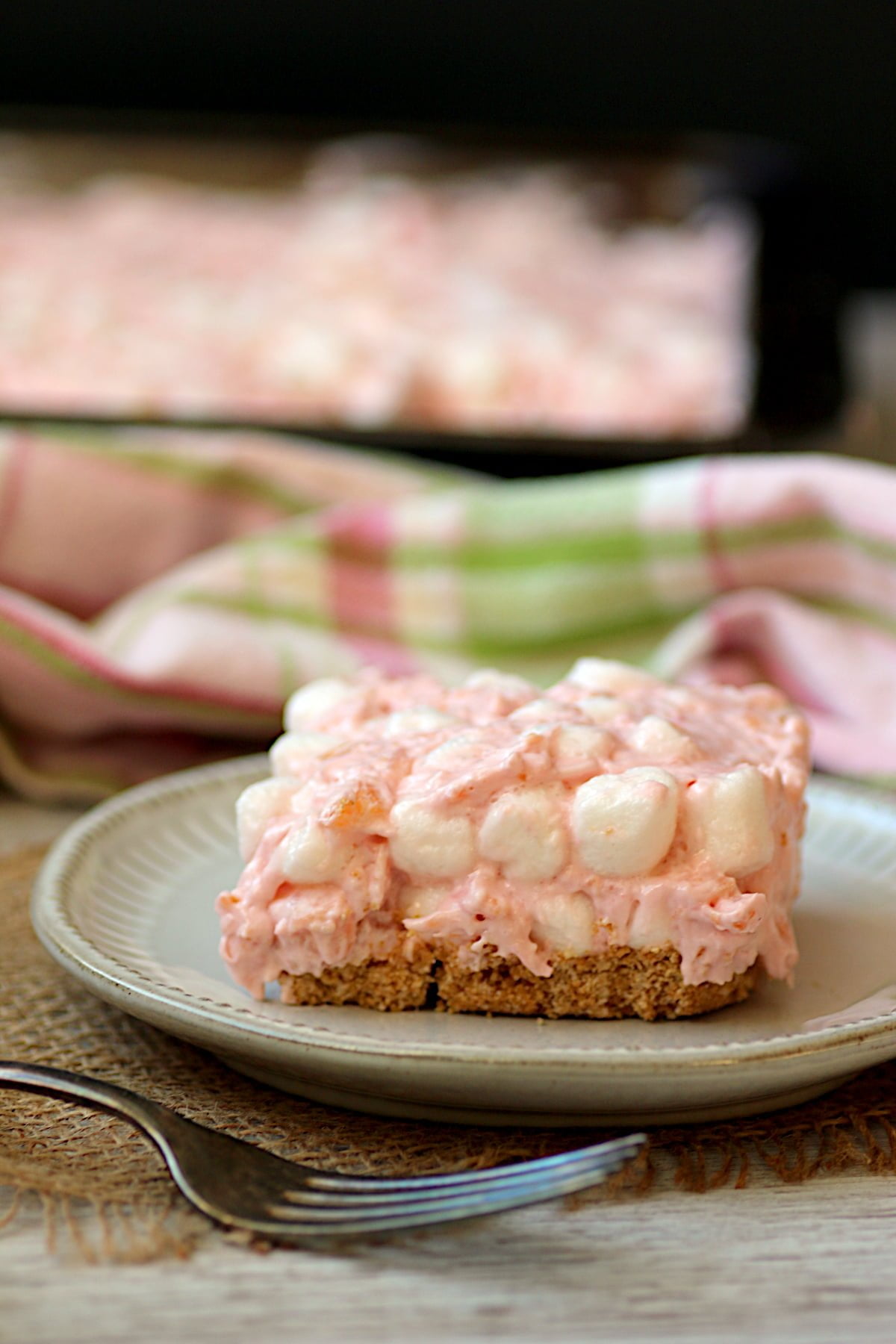 A tropical cherry ambrosia square on a white plate.