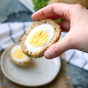 Scotch egg in hand cropped