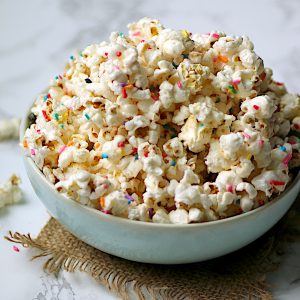 Homemade funfetti popcorn in a pale blue bowl.