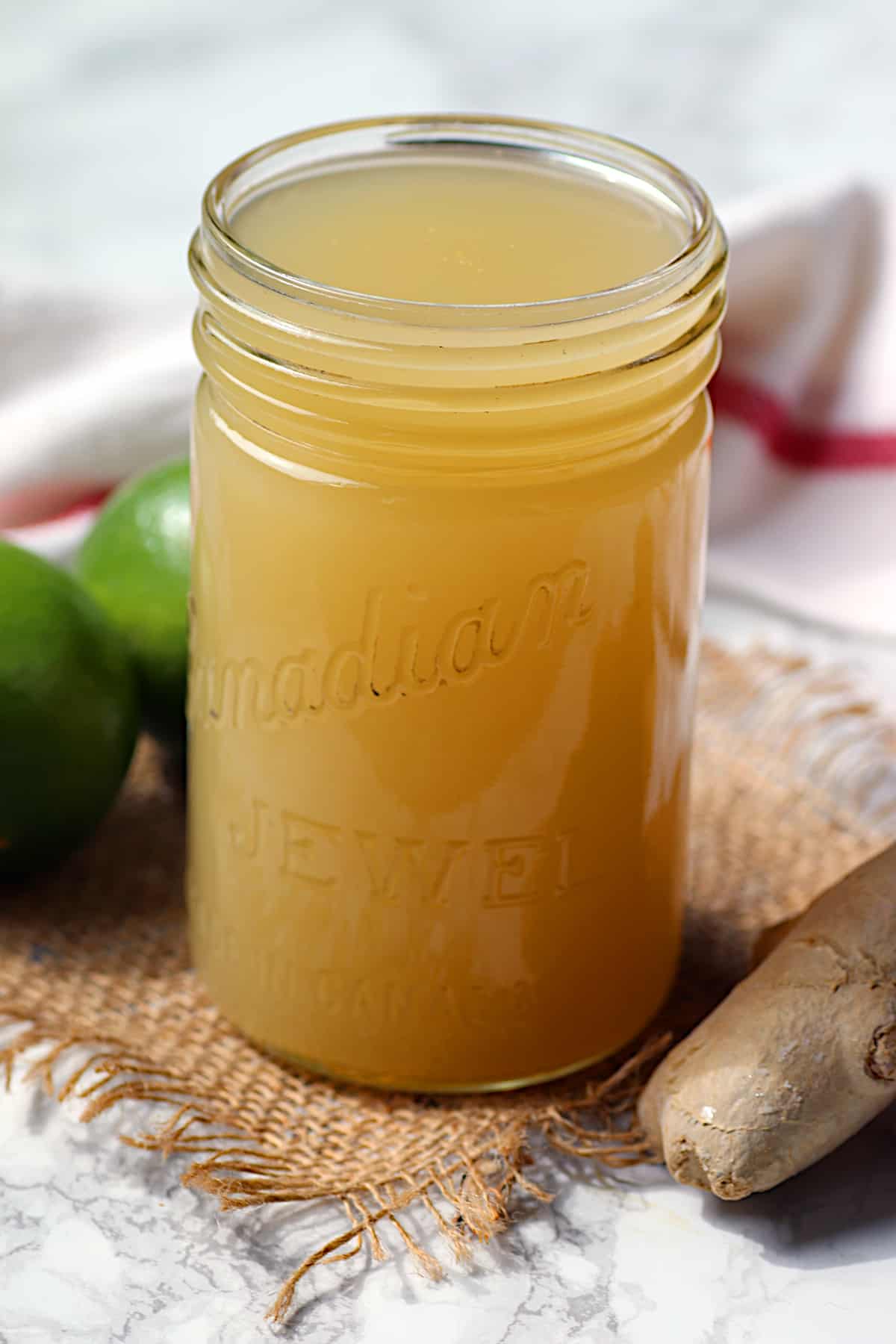 A vintage jar full of homemade ginger lime syrup.