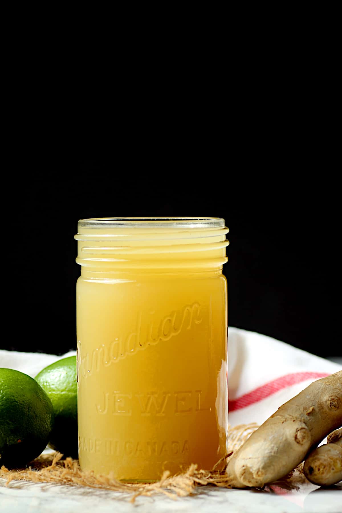 A vintage jar full of homemade ginger lime syrup.