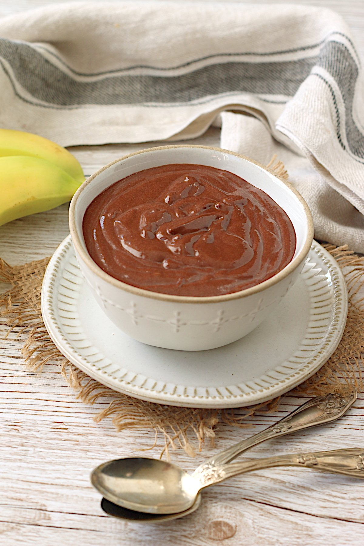 Homemade vegan chocolate banana pudding in a white bowl.