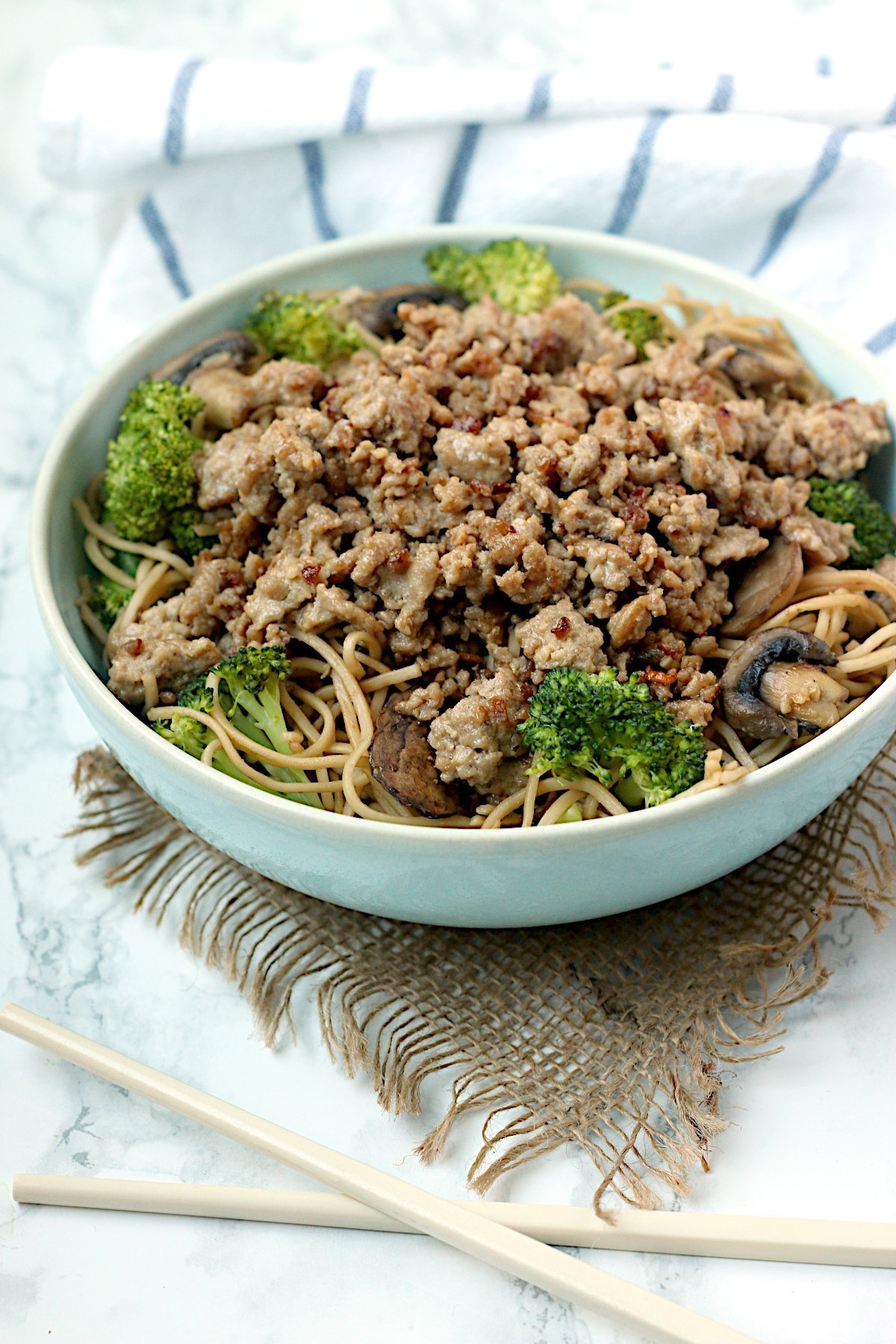 One-Pan Pork and Broccoli Noodle Bowl in a pale blue bowl.