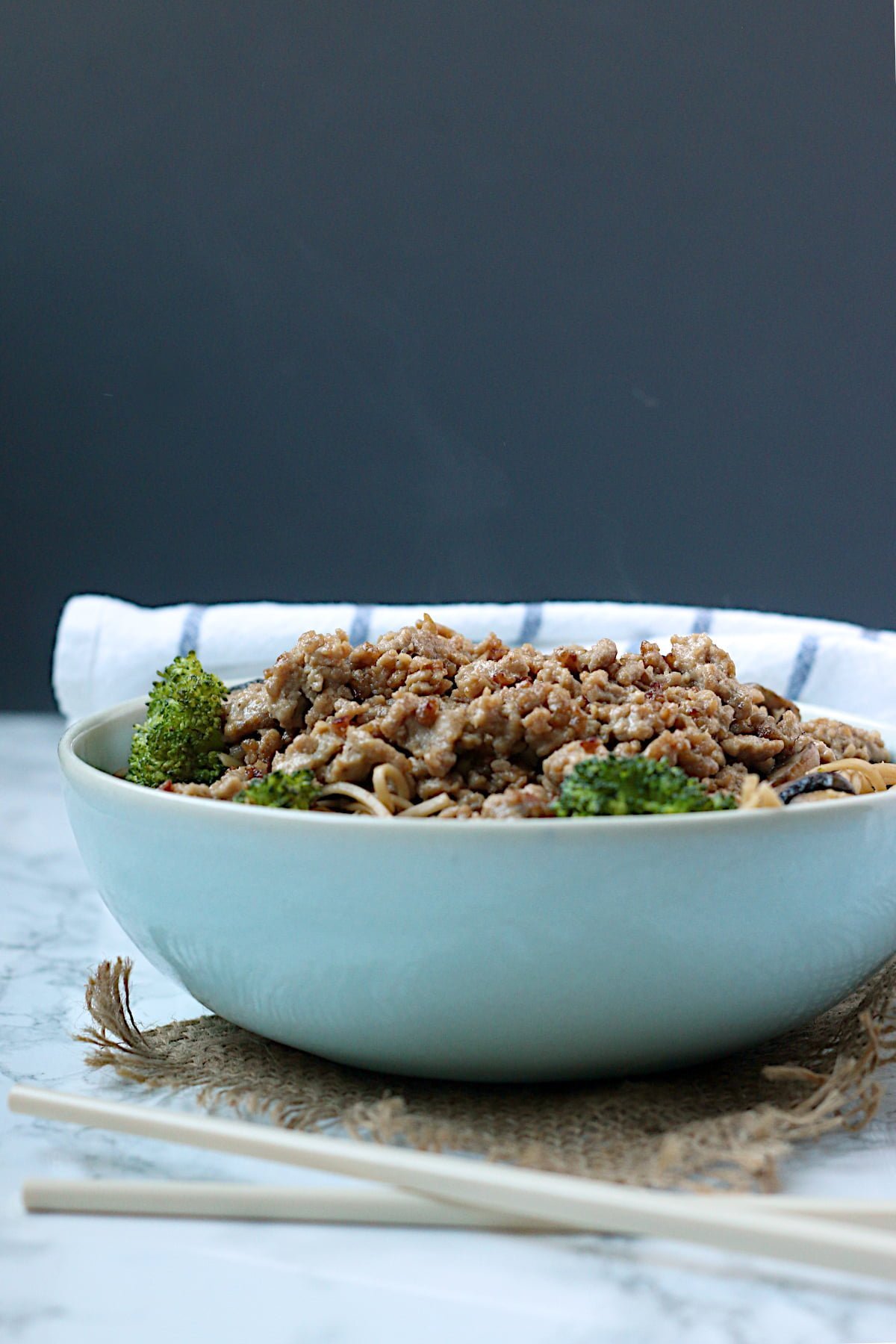 One-Pan Pork and Broccoli Noodle Bowl in a pale blue bowl.