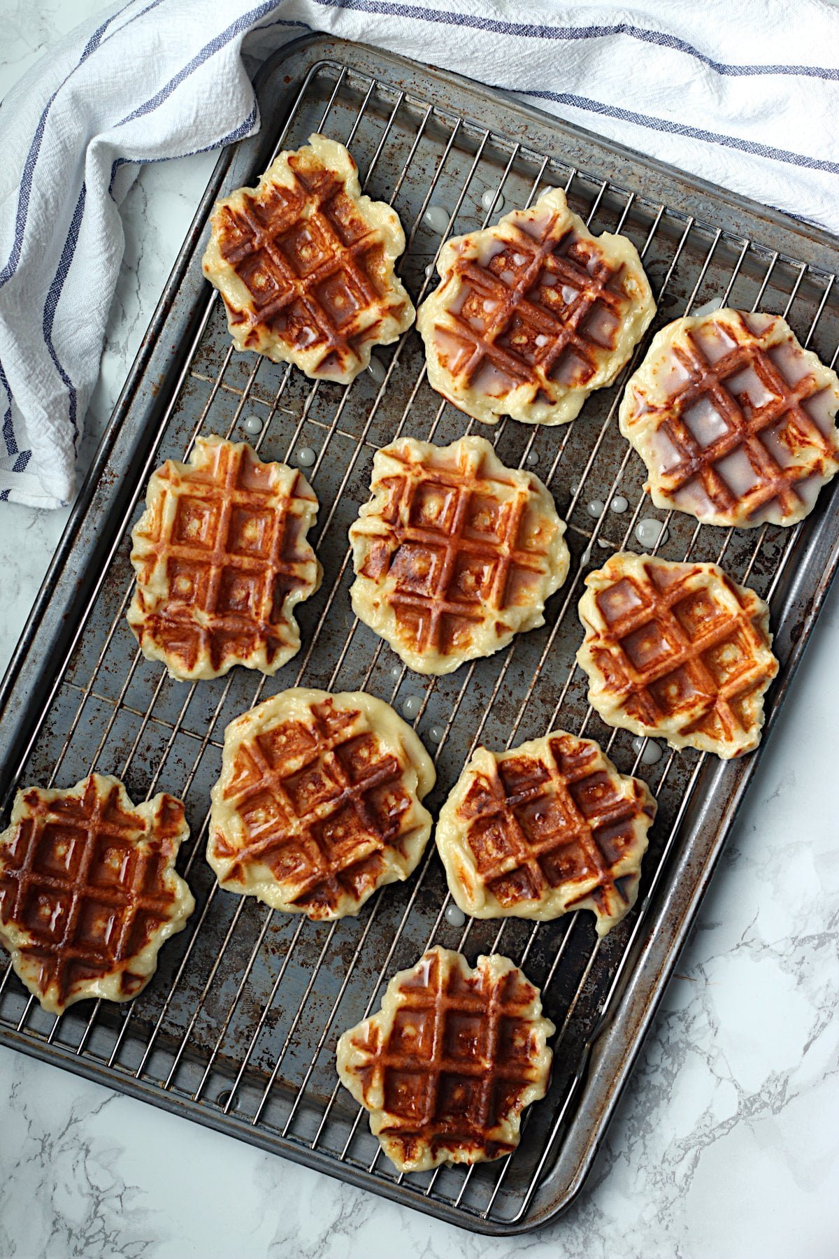Homemade honey cruller waffles on a baking sheet.