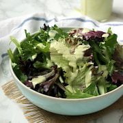 Homemade Creamy Pesto Salad Dressing on mixed salad greens