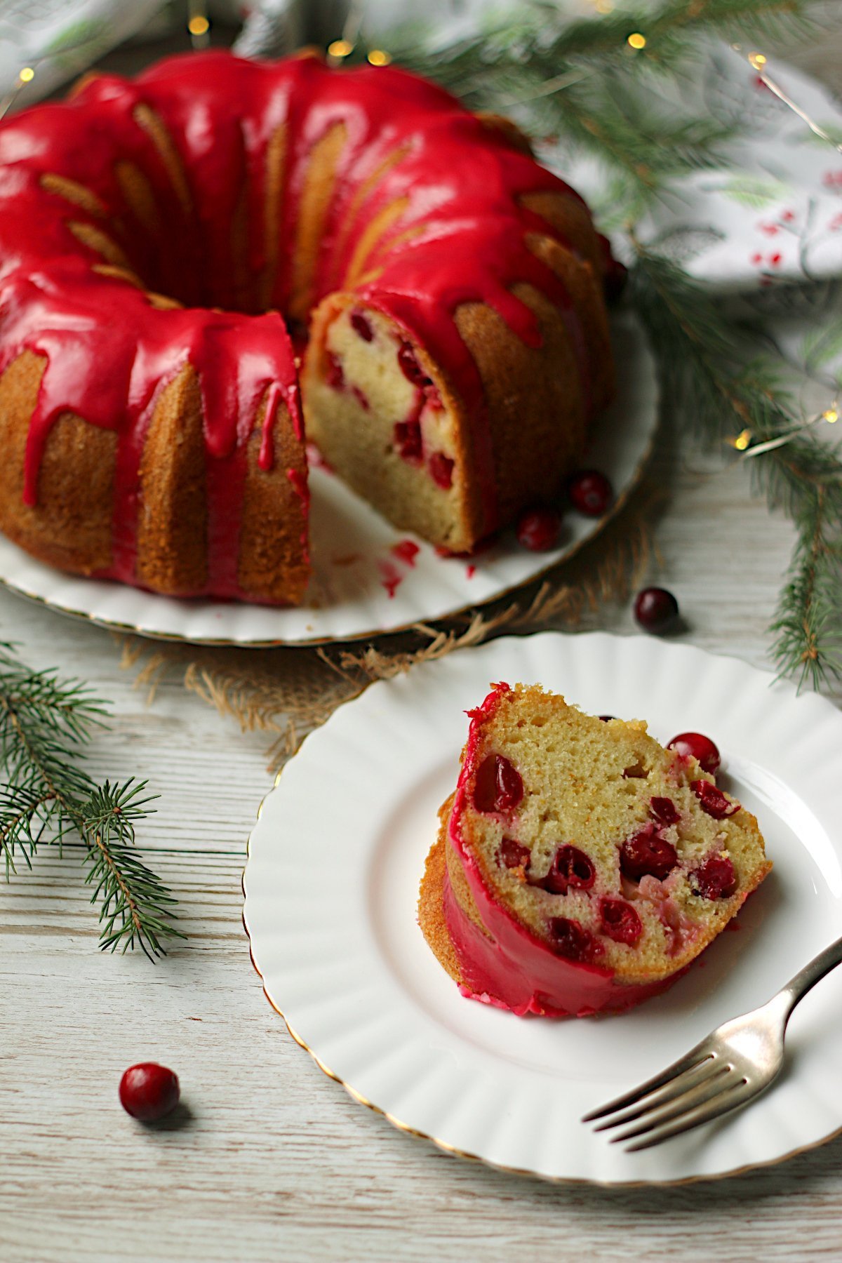 A slice of Cranberry Orange Bundt Plate on a small white plate.