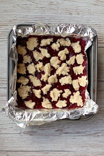 Unbaked cranberry pie bars in a foil-lined baking pan.