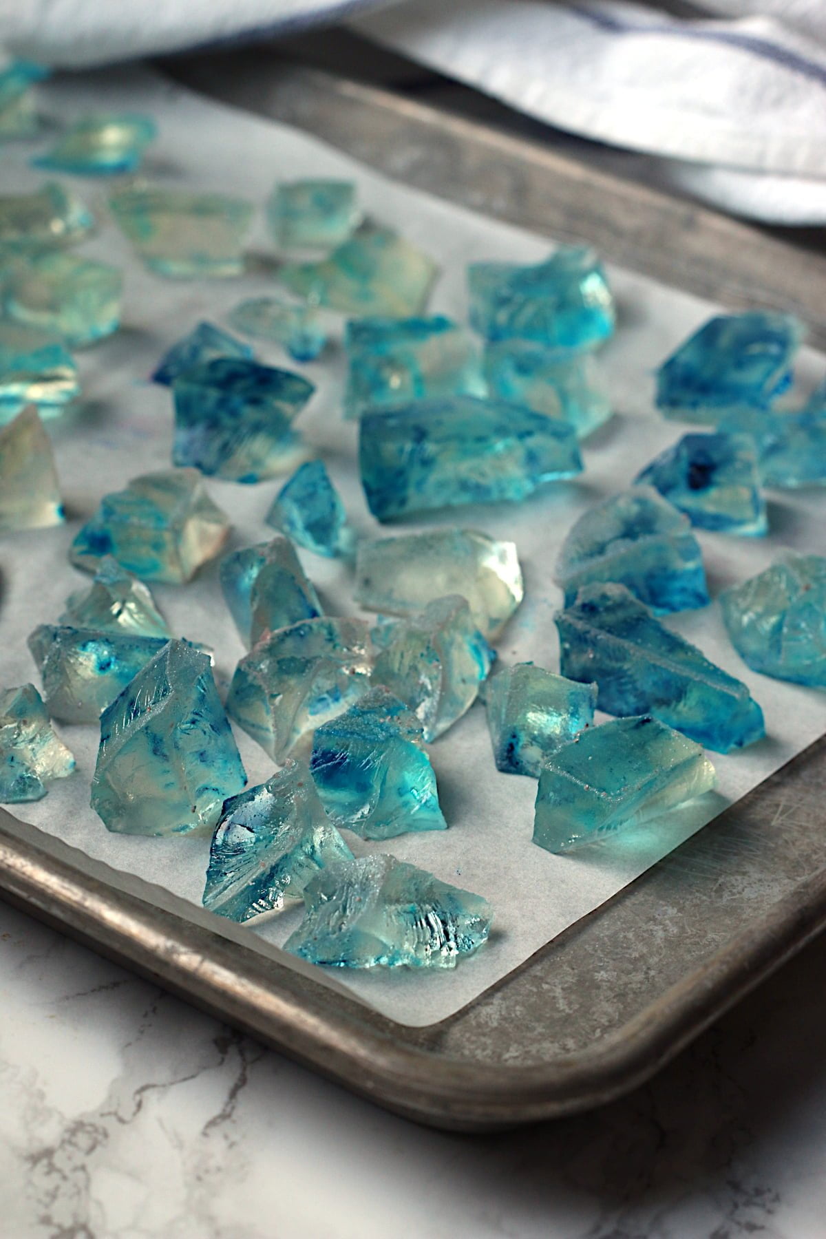 Blue Japanese Crystal Candy on a parchment-lined baking sheet.